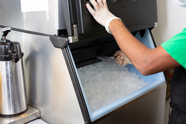 A-view-of-an-employee-scooping-ice-out-of-an-ice-machine.jpg