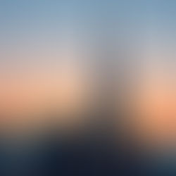 Skyline view of high-rise buildings during sunset with an overlay of financial charts