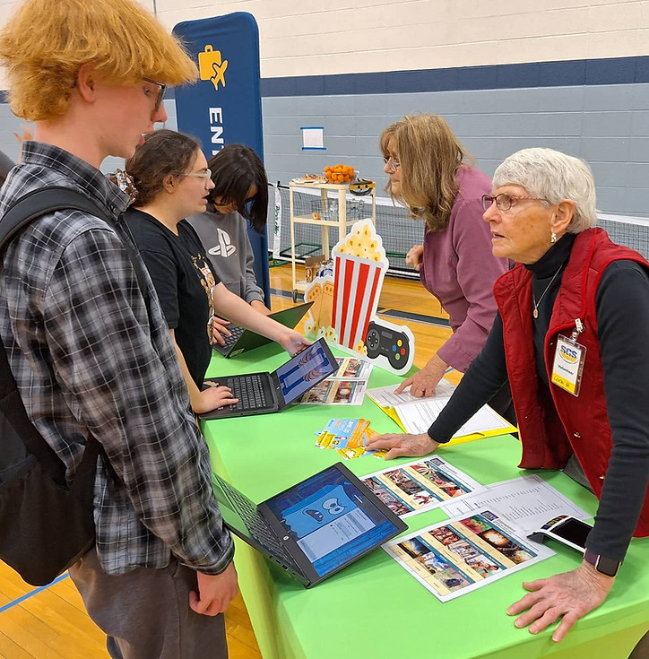 Older woman helping kids at booth