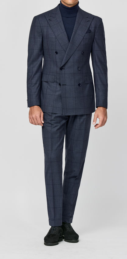 Man wearing a tailored double-breasted suit with a checkered pattern, styled with a turtleneck, showcasing bespoke tailoring from Allan David Bespoke in Calgary.