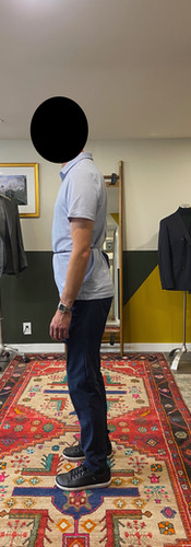 Side profile of a client showing forward head posture and slight anterior pelvic tilt, recorded during a bespoke fitting consultation at Allan David Bespoke in Calgary.