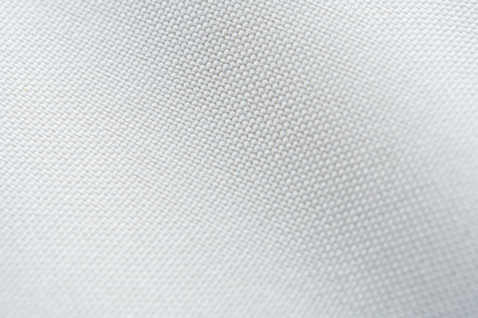 Close-up of textured white oxford fabric weave pattern. The image is simple and clean, creating a neutral and calm mood.