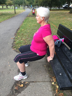 Client doing tricep dips on bench