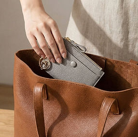 Close-up of a brown tote bag interior with a small zip pouch placed inside