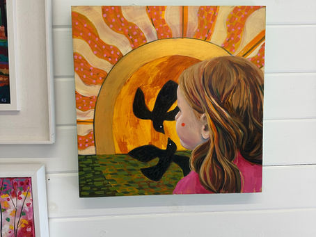 Child looking out at a sun and two birds dancing