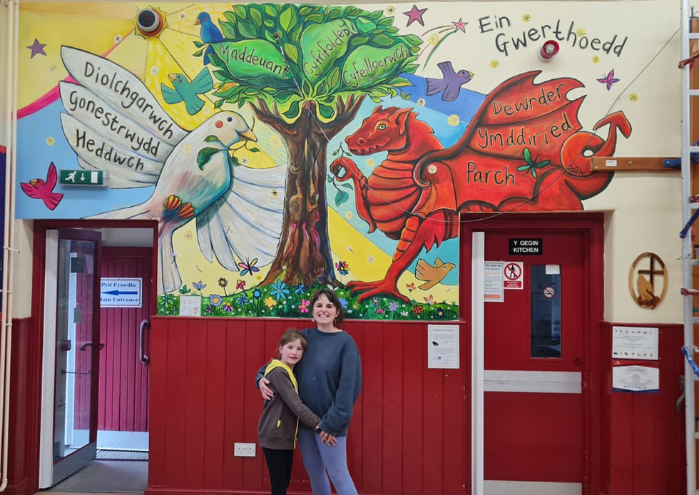 Chloe Elliott Schmid Art working on a local community school mural project