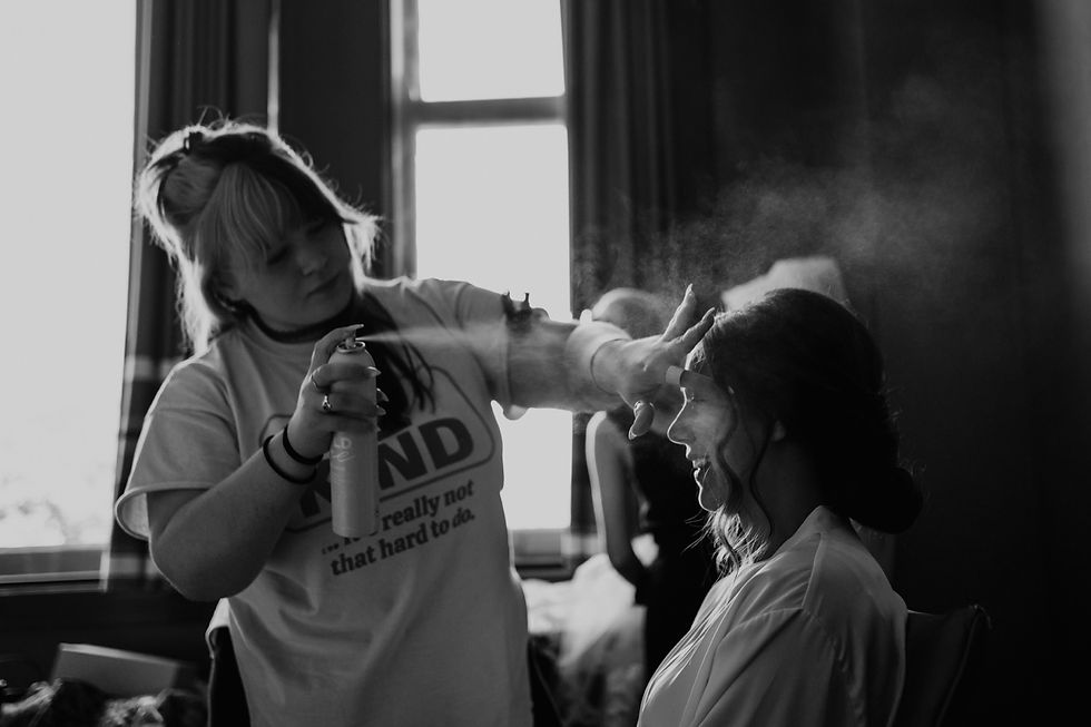 Hair and makeup team getting ready for wedding day. Michigan wedding photography by Nicole Leanne Photography