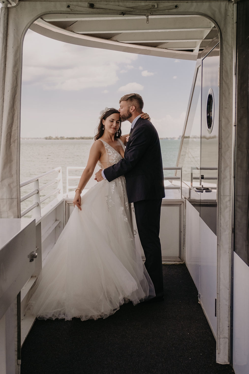 Bride and groom on Detroit Ovation Infinity yacht for wedding reception. Detroit wedding photography by Nicole Leanne Photography