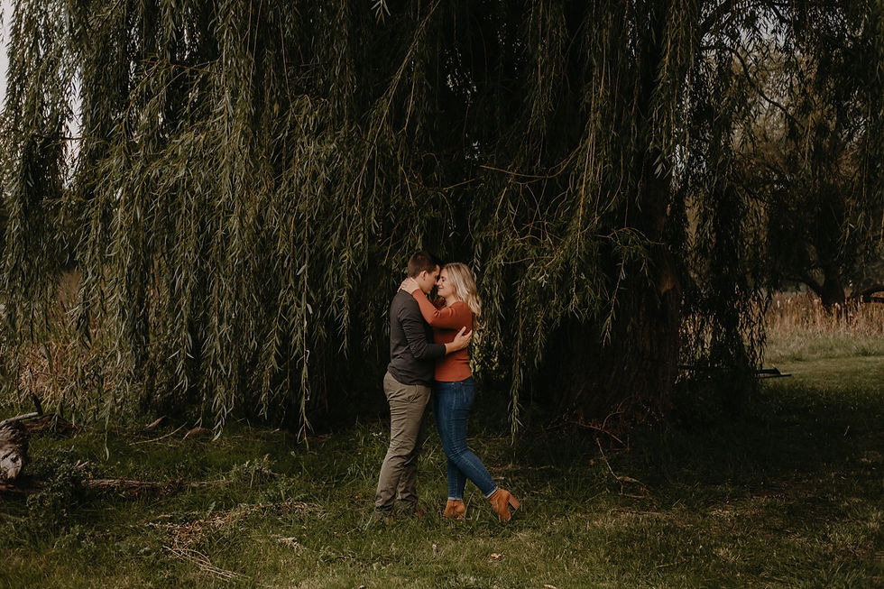 Engagement session under the trees in Metro Detroit. Engagement photography by Nicole Leanne Photography