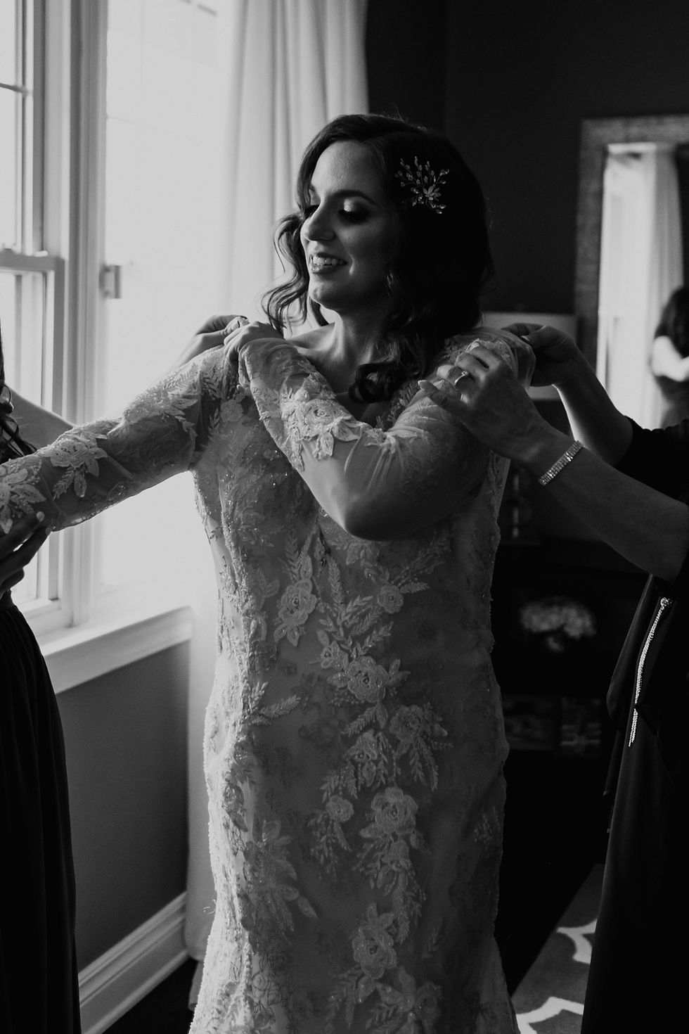 Bride putting on wedding dress. Photographed by Nicole Leanne Photography.