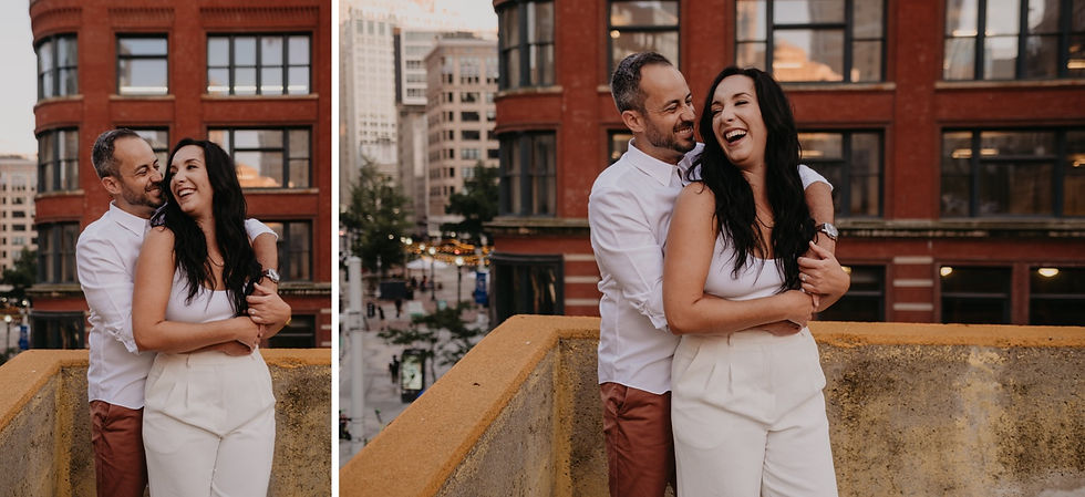 Laughing couple with view of downtown Detroit. Metro Detroit engagement photography by Nicole Leanne Photography