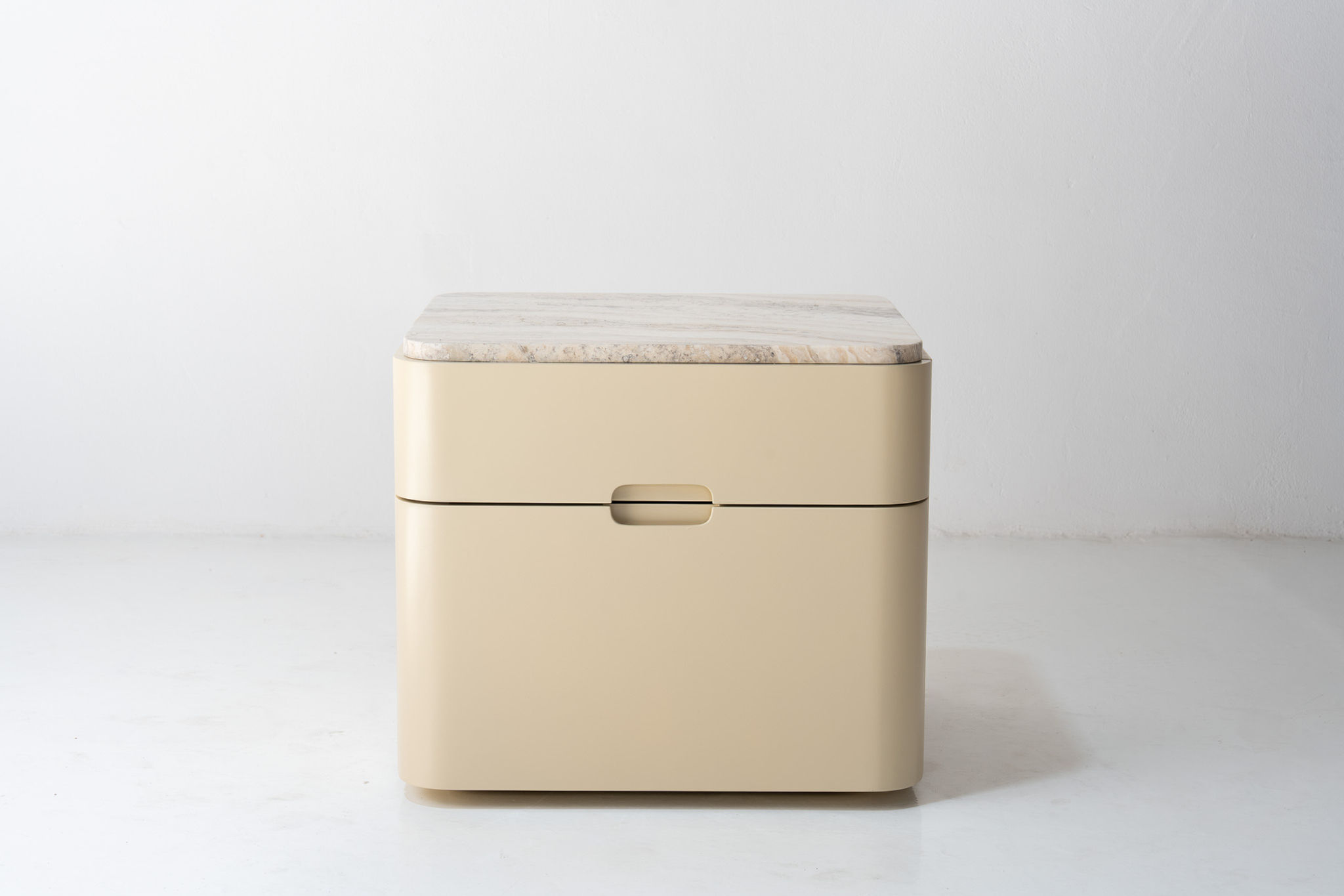Avena travertine bedside table in Dubai with curved design and genuine travertine top by Adams Furniture