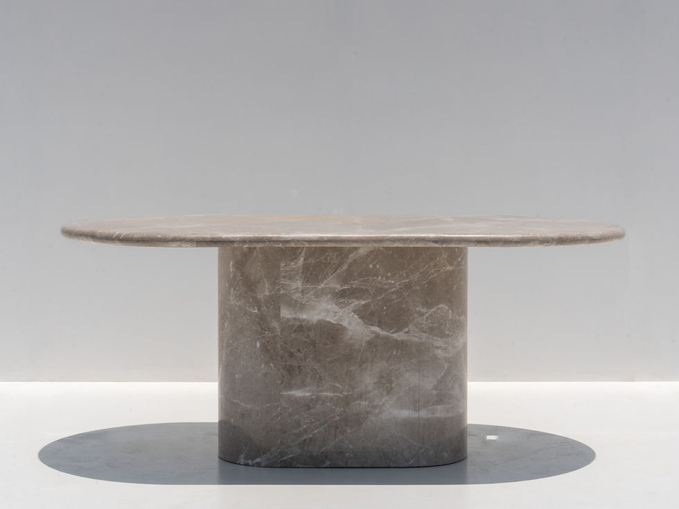 Monza Oval Marble Dining Table in Dubai with a warm grey natural marble top, rounded edge profile and sculptural pedestal bas