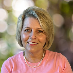 Portrait of Courtney Cooper, a warm and experienced therapist, in a calm setting reflecting her compassionate and empowering therapeutic style.