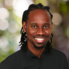 Portrait of Benjamin Miller, a thoughtful and supportive therapist, in a welcoming space that reflects his eclectic and strength-based counseling style.