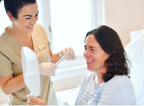 client chatting to staff member post-treatment