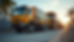 Eye-level view of a mobile tire service truck parked next to a large construction vehicle on a site in Miami
