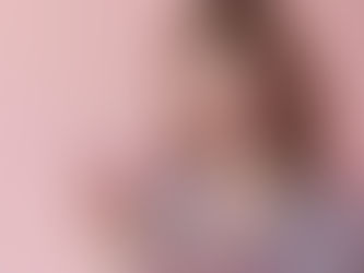 Woman holds a glass of collagen drink, smiling against a pink background.