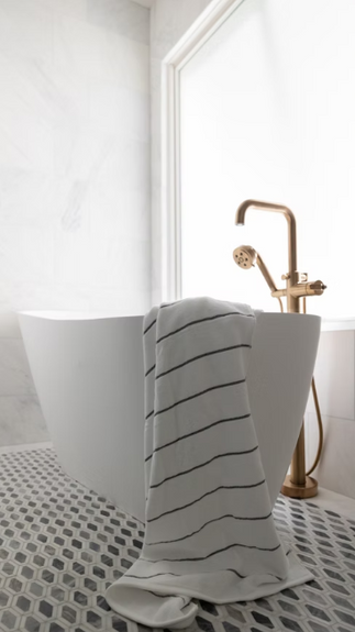 Stunning bath tub area in this Isle of Palms primary bath, designed by Tailored Designs in Charlotte, NC. 