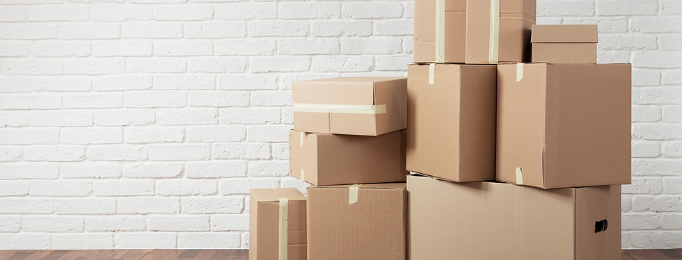 Moving in. Stack of cardboard boxes in the empty room with copy space.jpg