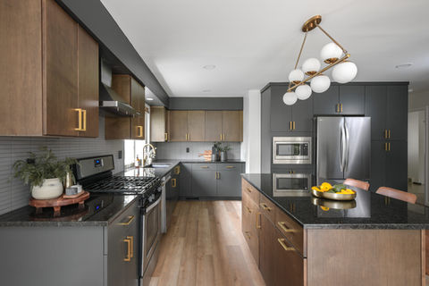Modern two-tone kitchen cabinets in charcoal and natural wood by a boutique cabinetry designer in Asheville, NC.