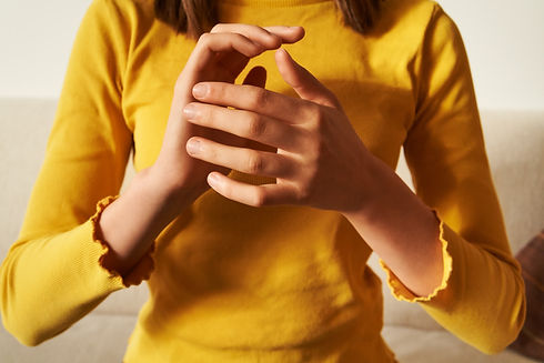 Young teenage girl top practicing EFT or emotional freedom technique - tapping on side of