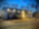 A blue apartment building at night.