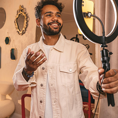 Content Creator filming themselves: Personalized guidance designed to refine your craft, strengthen your brand, and establish your presence in the industry. Our management services provide the strategic support, mentorship, and opportunities you need to grow and sustain a successful creative career.