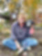 Betsy Vosburgh sitting in her garden with her dog Hart next to her.