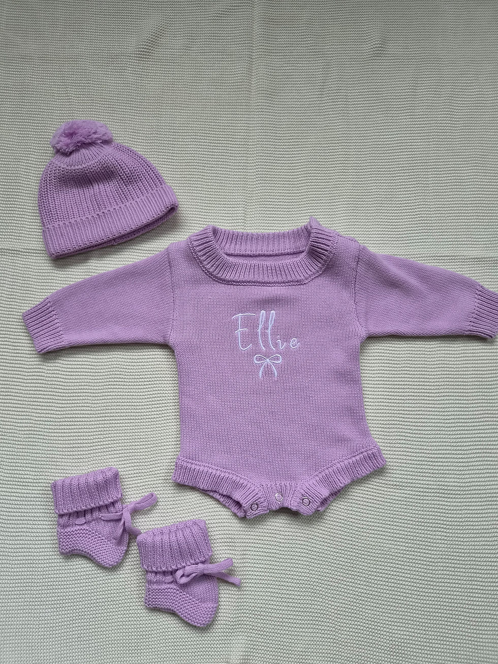 Lilac Knit Romper With the Name Ellie and a bow Embroidered in white thread matching hat and boots
