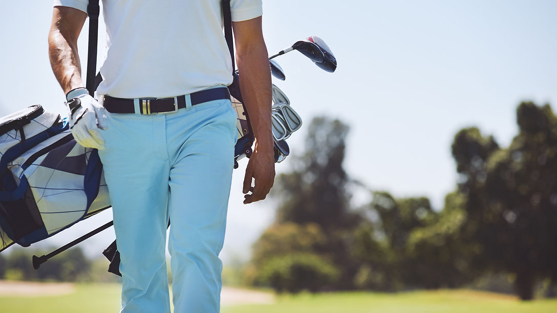 Man Carrying Golf Bag