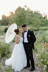 A bride and groom standing in a garden during sunset at Glen Ellen