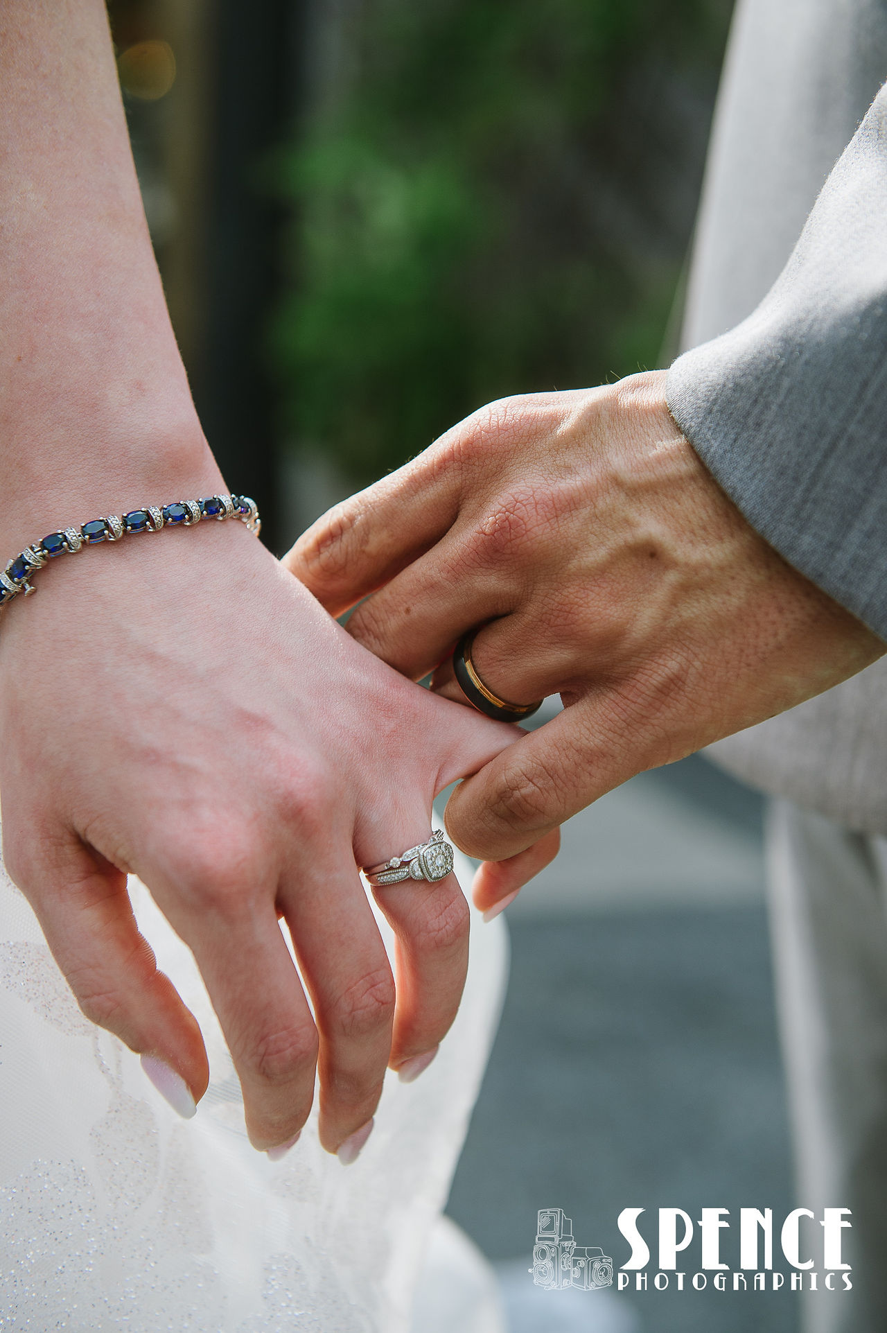 Two hands with wedding rings.