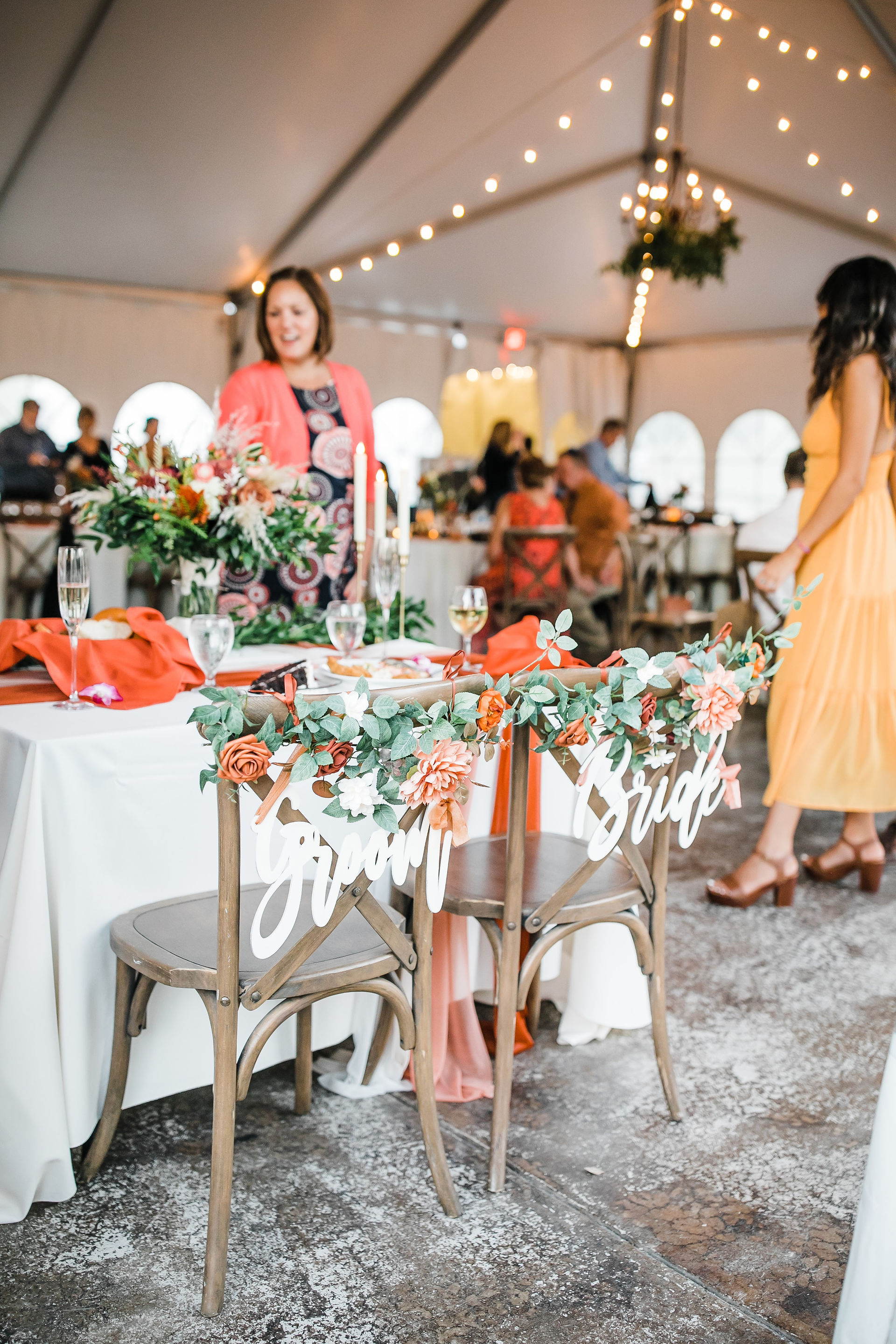 Bride and groom signs on the sweetheart table.