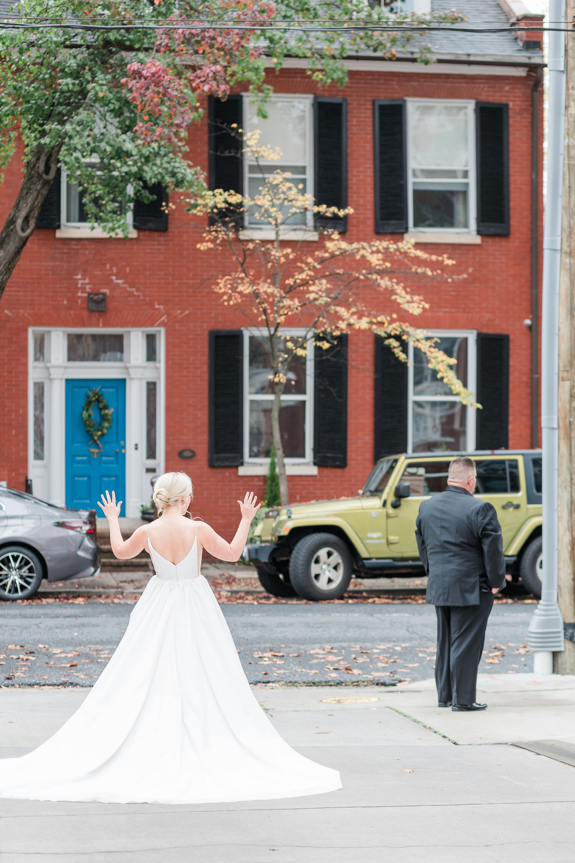 a bride on the streets of downtown frederick with a man's back to her