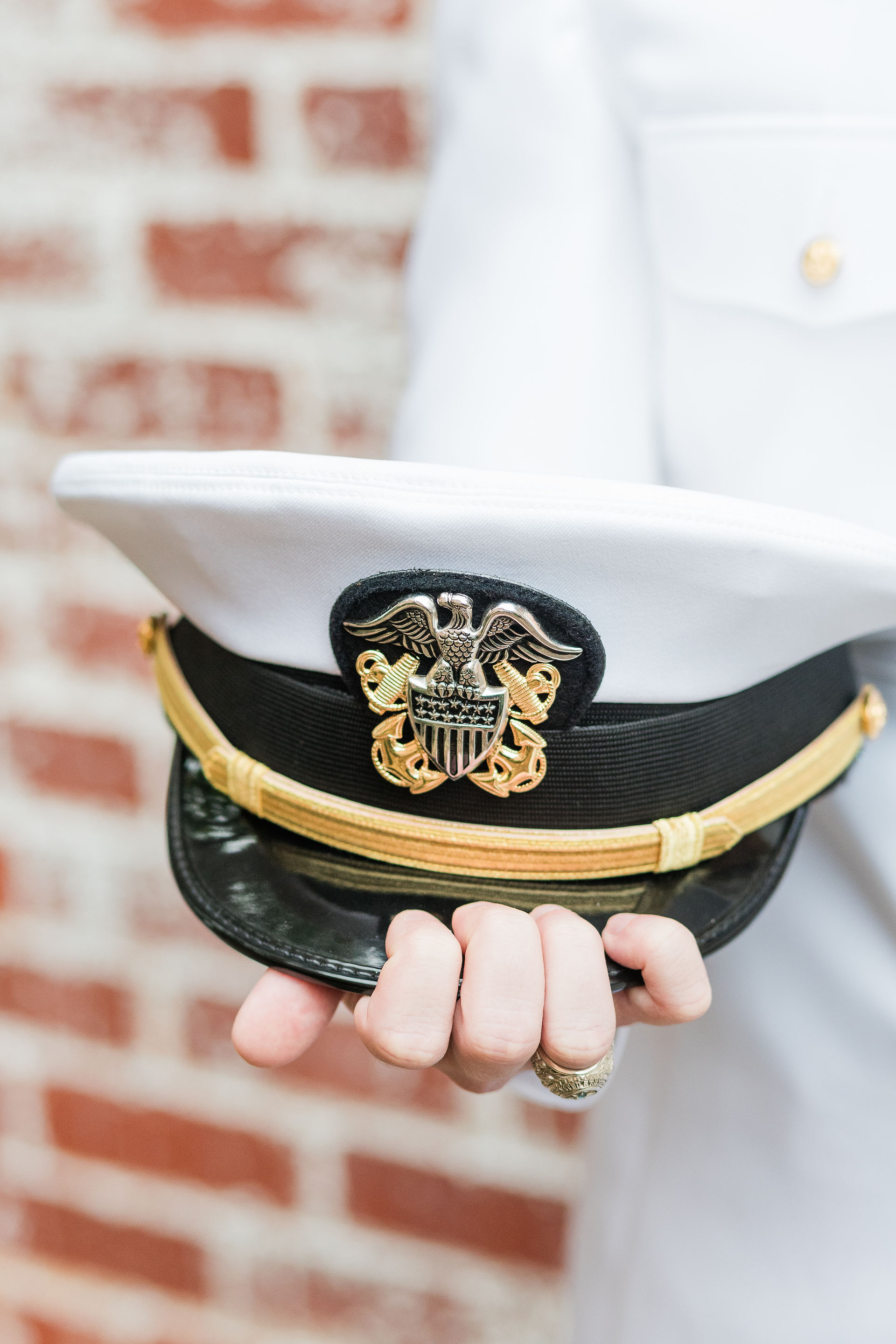 a navy men's hat sitting in his hand