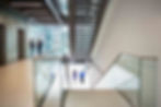 Businessmen discussing plans in office hallway.jpg