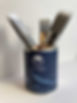 paint brushes in blue tin