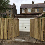 Gates opening onto driveway and garage