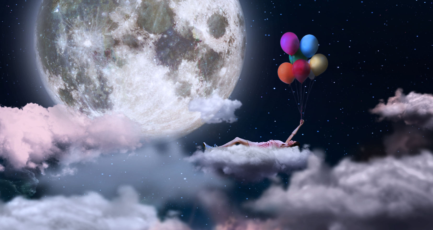 A woman holding on to colored balloons,