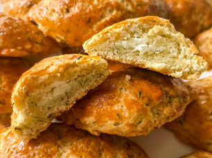 Baked Turkish pastries (poğaça) filled with feta cheese and dill, fresh out of the oven