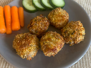 Ev yapımı fırında tavuk nugget, yanında havuç ve salatalıkla birlikte çocuklar için sağlıklı bir şekilde servis edilmiş