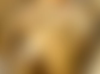 Juicy whole roasted chicken with golden crispy skin, cooked with olive oil, butter, salt and pepper, resting on parchment paper.