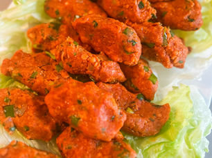 Turkish lentil patties (mercimek köftesi) arranged over fresh lettuce leaves, ready to serve