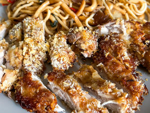 Crispy baked chicken thighs coated in panko breadcrumbs, served with noodles
