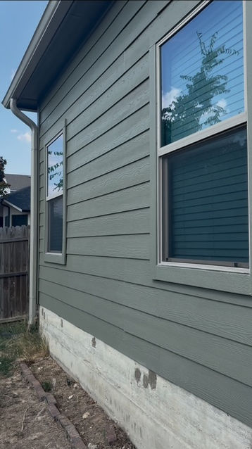 Finished window trim and exterior siding after painting
