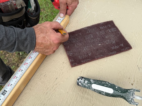 Handyman measuring a wooden block