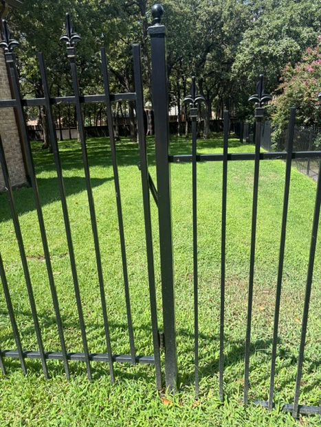 Black wrought iron fence before repair