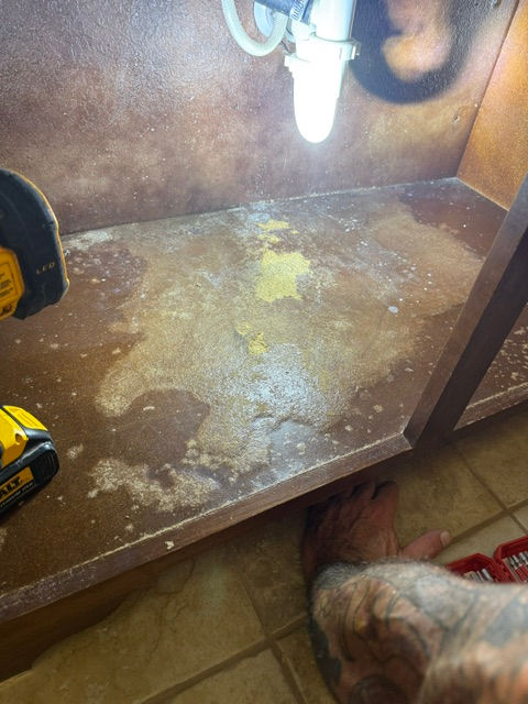 Damaged cabinet base before repair in Keller TX