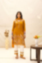 female model posing in mustard muse by mukhtar sarees gul season 3 of mustard color and 100% giza cotton kurta/pant and checks organza dupatta